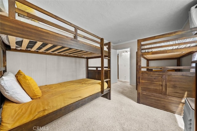 carpeted bedroom featuring a textured ceiling and crown molding