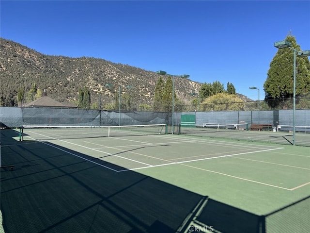 view of sport court with a mountain view