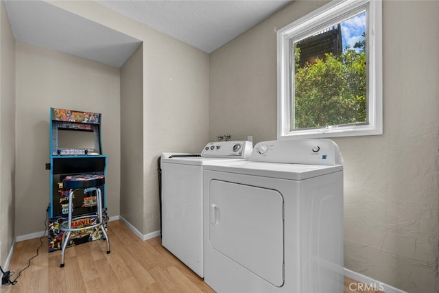 laundry room featuring light hardwood / wood-style flooring and washer and dryer