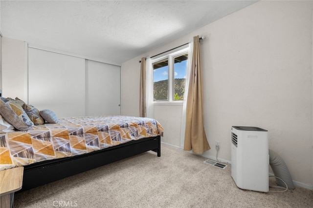 carpeted bedroom featuring a textured ceiling