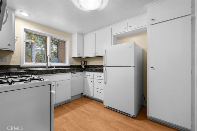 kitchen with white appliances, light hardwood / wood-style floors, white cabinetry, and a textured ceiling