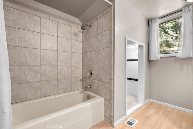 bathroom with shower / bath combination with curtain and hardwood / wood-style flooring