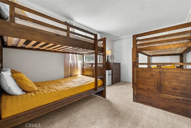 bedroom with carpet floors and a textured ceiling