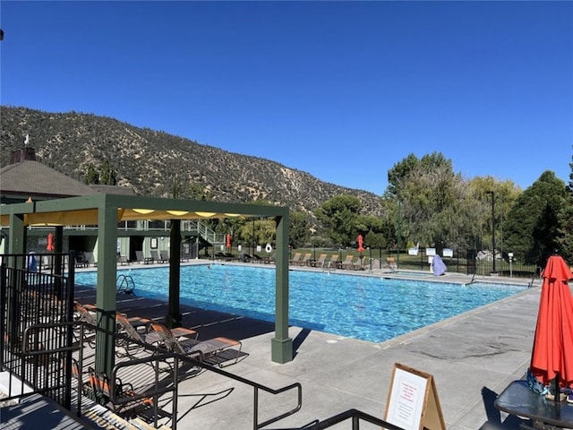 view of pool featuring a patio and a mountain view