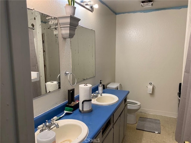 bathroom featuring toilet and vanity