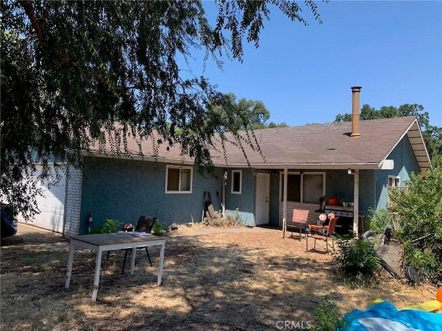 back of house with a garage