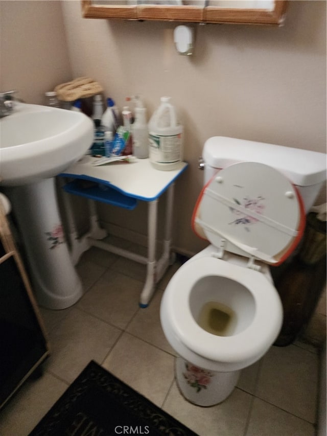 bathroom featuring toilet and tile patterned flooring