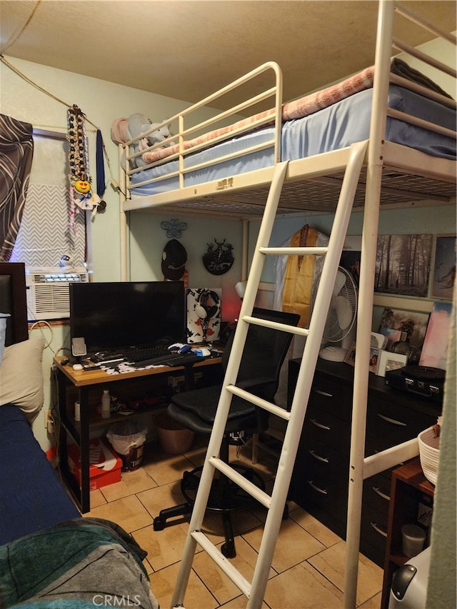 bedroom with cooling unit and tile patterned flooring