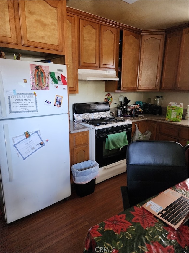 kitchen with dark wood-type flooring and white appliances