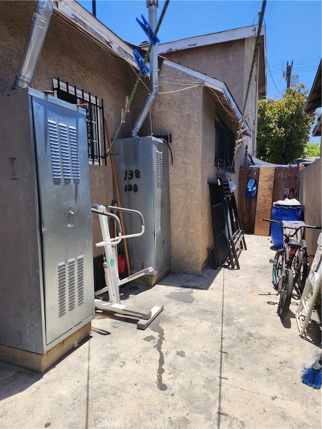 rear view of property with a patio and heating unit