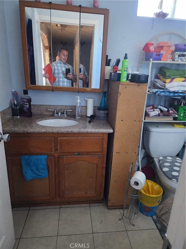 bathroom with vanity, toilet, and tile patterned flooring