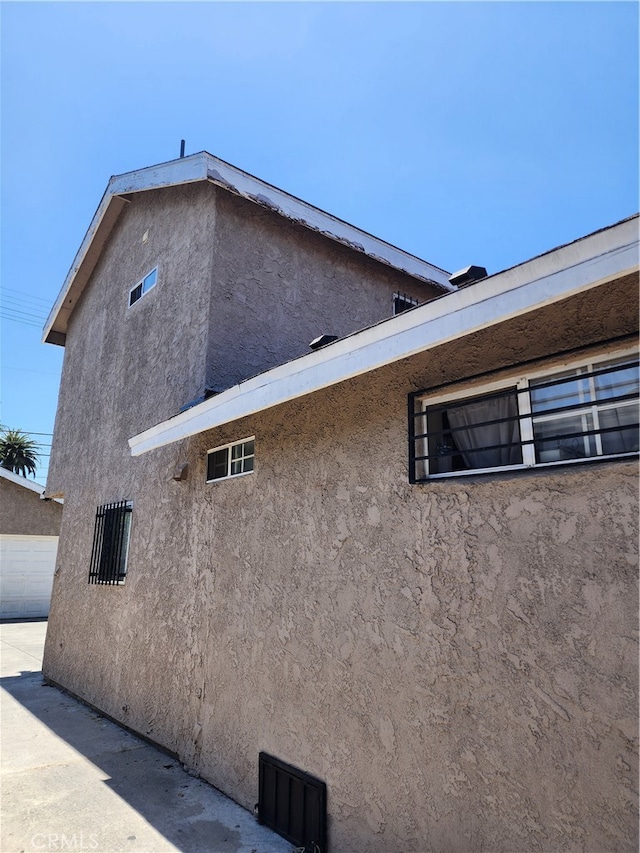 view of side of home with a garage