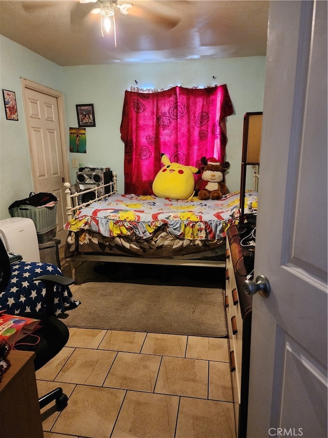 tiled bedroom with ceiling fan