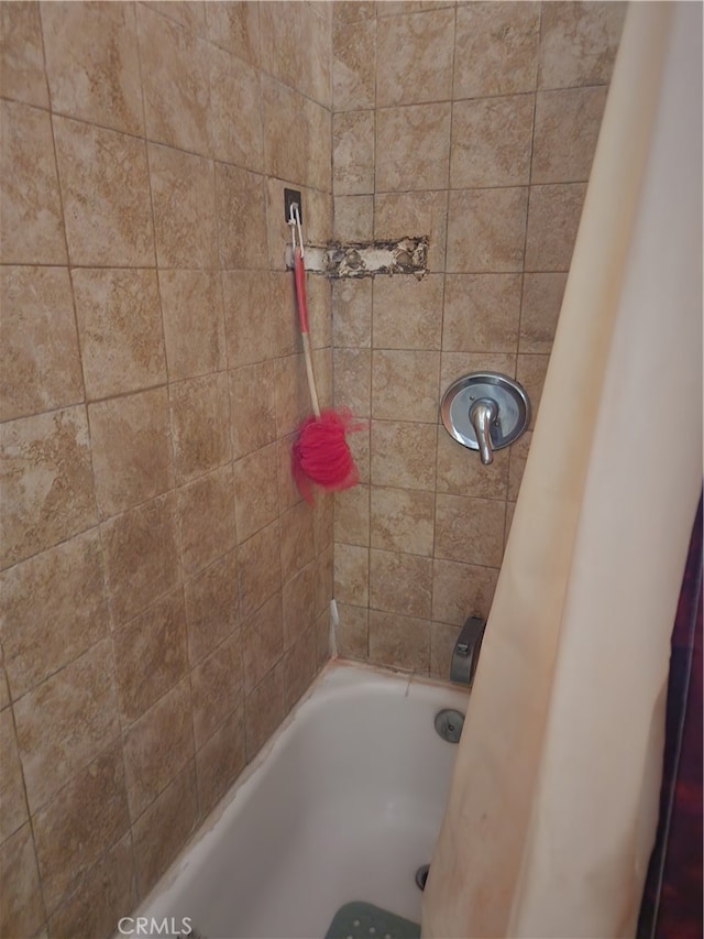 bathroom with shower / bath combination with curtain