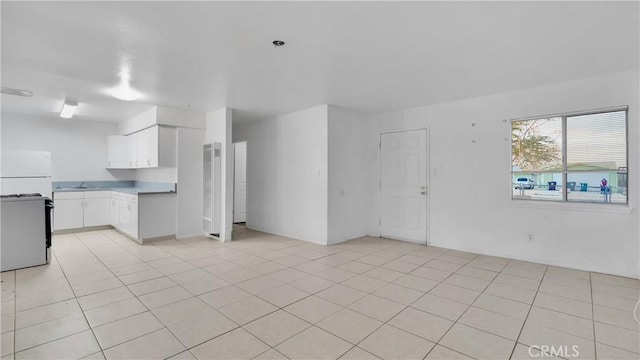 unfurnished living room with light tile patterned floors