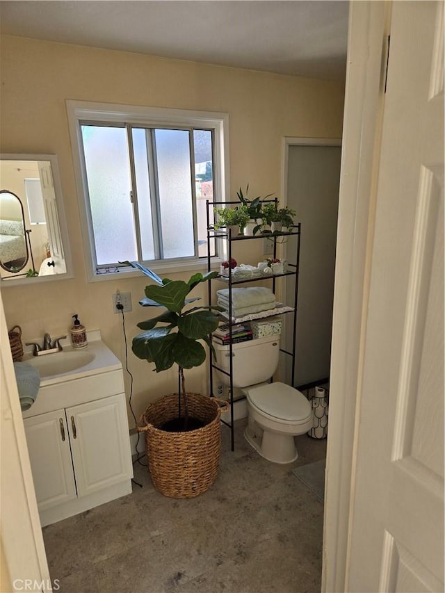 bathroom with toilet and vanity