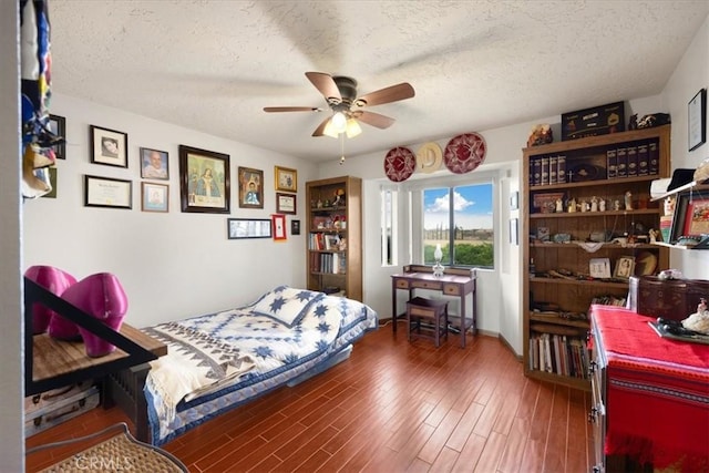 bedroom featuring a textured ceiling, ceiling fan, and dark wood-type flooring