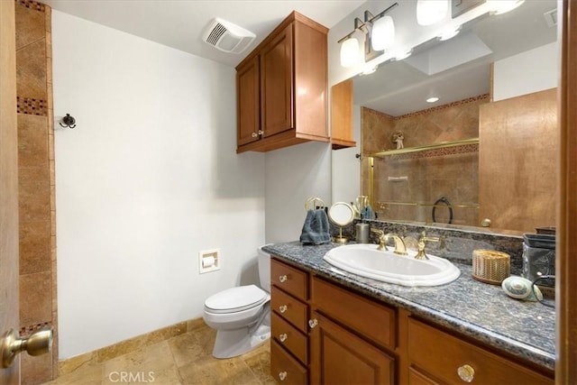 bathroom featuring vanity, toilet, and tiled shower