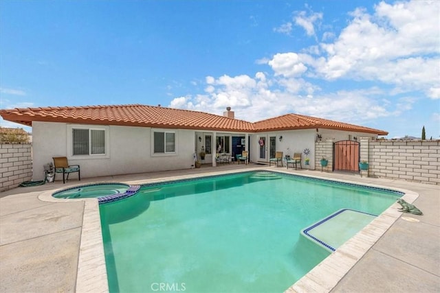 view of pool with a patio area and an in ground hot tub