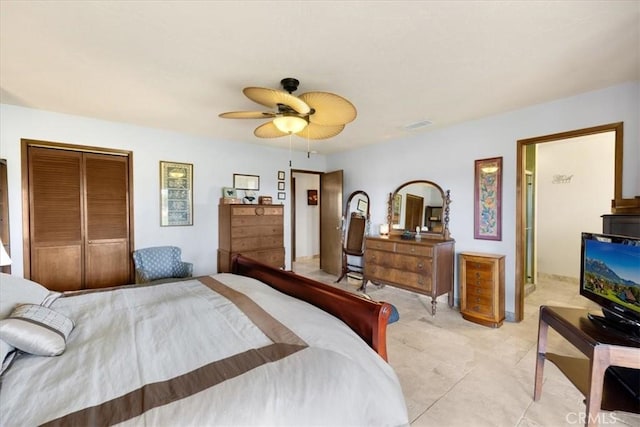 tiled bedroom featuring ceiling fan and a closet