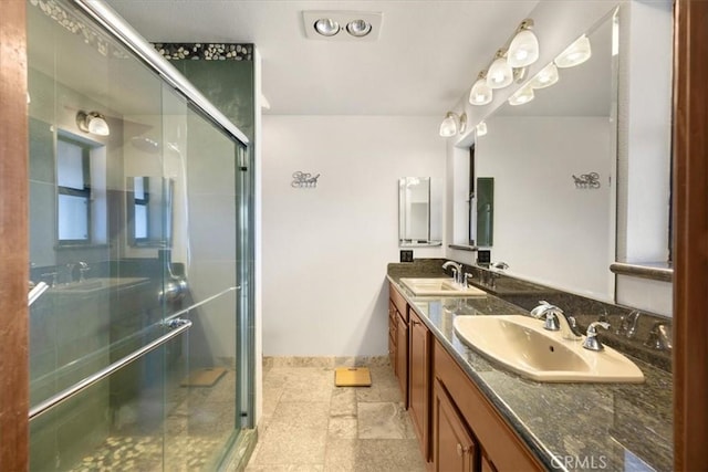 bathroom with tile patterned floors, a shower with door, and vanity