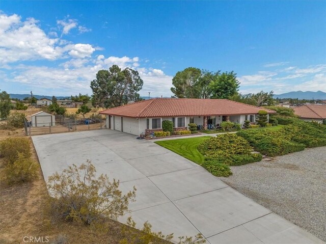 single story home featuring a mountain view and a garage