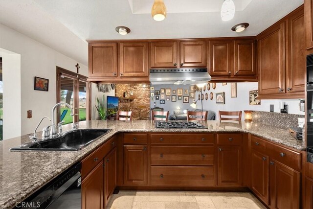 kitchen featuring kitchen peninsula, gas stovetop, sink, stone countertops, and dishwasher