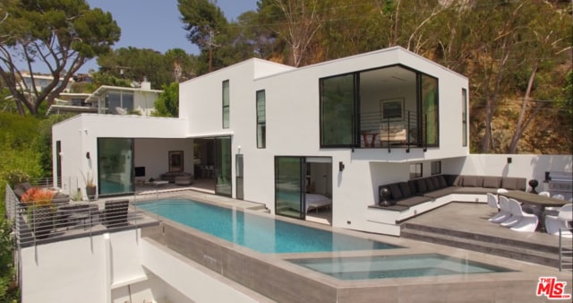 back of house featuring a patio and a swimming pool with hot tub