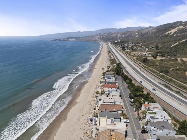 birds eye view of property with a beach view and a water and mountain view