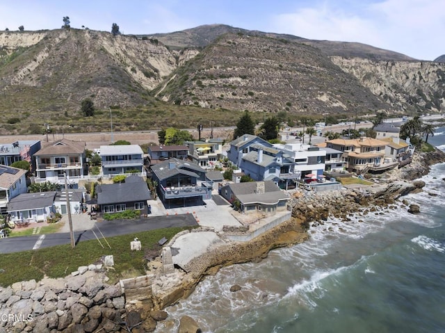 birds eye view of property with a water and mountain view