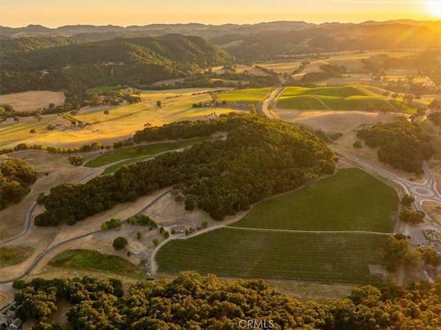 aerial view at dusk with a rural view and a mountain view