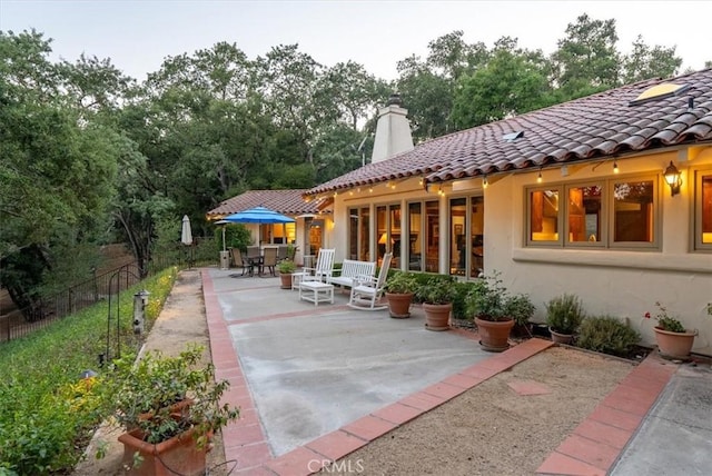 view of patio with outdoor dining space and fence