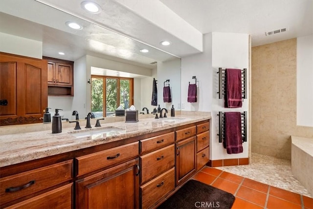 full bath with double vanity, a sink, visible vents, and tile patterned floors