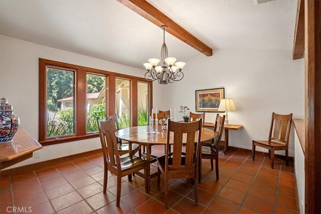 dining space with dark tile patterned flooring, a notable chandelier, vaulted ceiling with beams, and baseboards