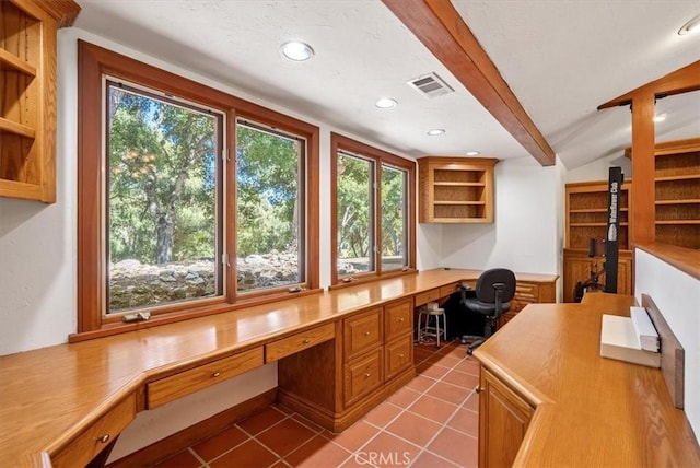 unfurnished office featuring visible vents, lofted ceiling with beams, tile patterned flooring, built in desk, and recessed lighting