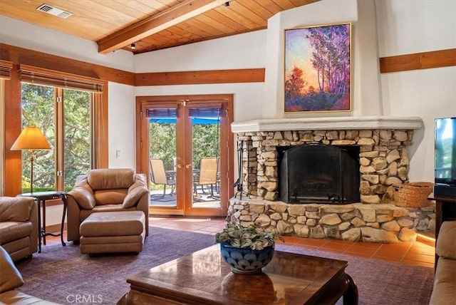 living room featuring vaulted ceiling with beams, visible vents, a stone fireplace, wooden ceiling, and tile patterned floors