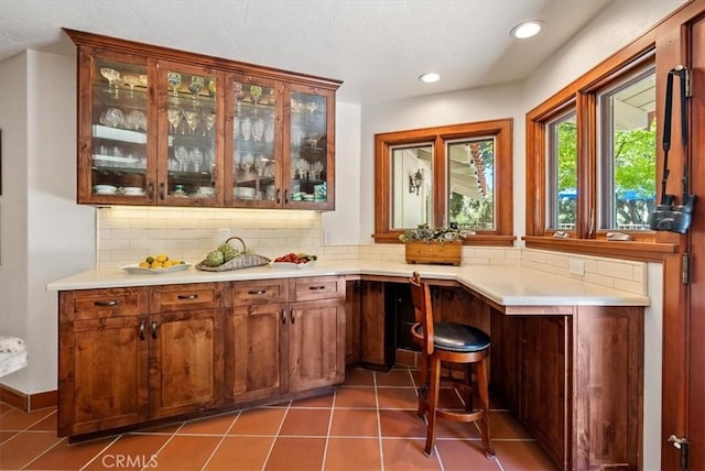 bar with recessed lighting, backsplash, and tile patterned floors