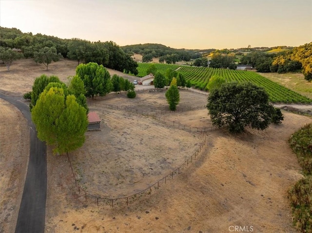 aerial view at dusk featuring a rural view