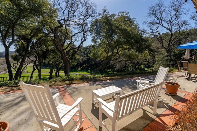 view of patio / terrace with outdoor dining space and fence