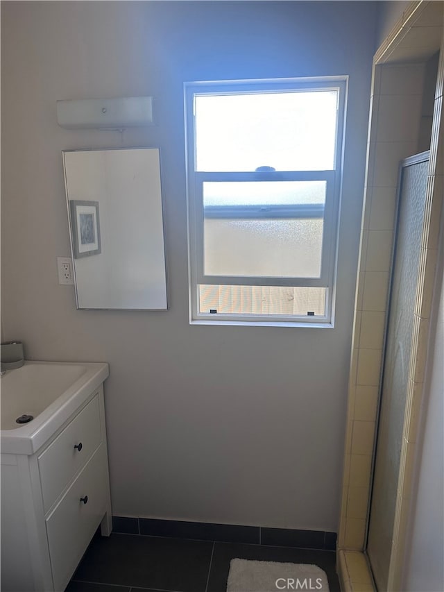 bathroom featuring vanity, an enclosed shower, tile patterned flooring, and plenty of natural light