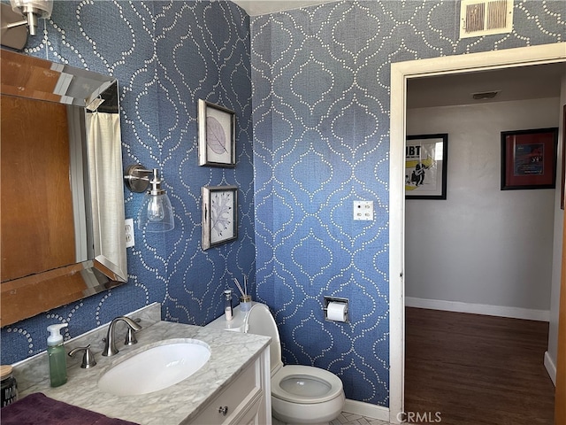 bathroom featuring vanity and toilet