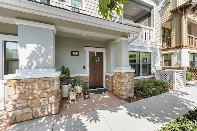 view of exterior entry featuring a porch