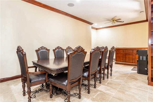 dining room with ceiling fan, ornamental molding, light tile patterned flooring, and baseboards