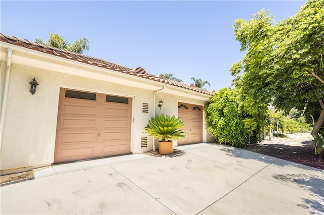 garage featuring concrete driveway