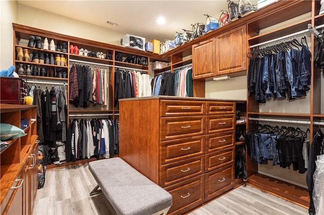 spacious closet with light wood-type flooring and visible vents