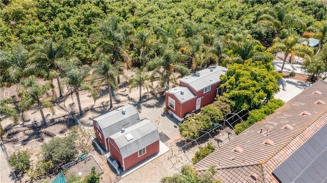 birds eye view of property with a view of trees