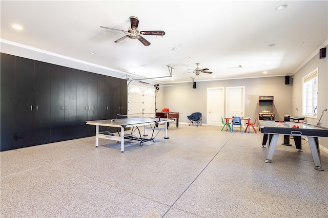 rec room featuring light speckled floor, crown molding, and a ceiling fan