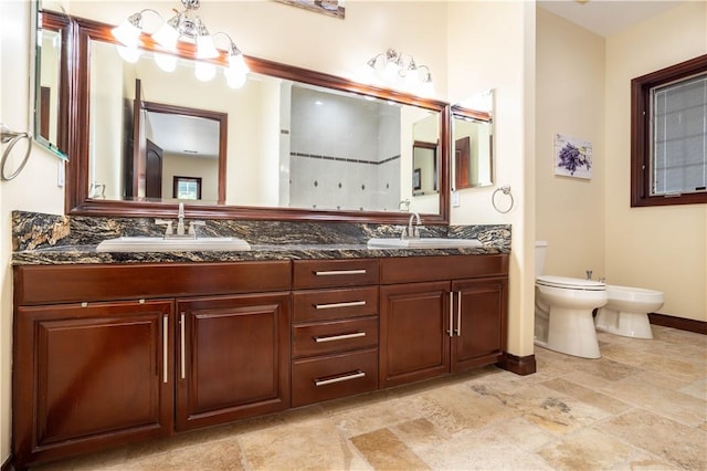 full bath featuring double vanity, a bidet, a sink, and toilet