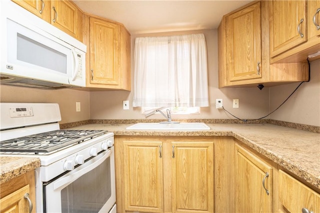 kitchen with white appliances and a sink