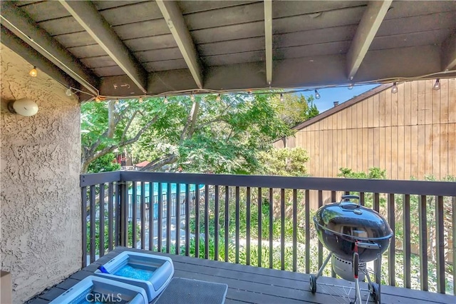 wooden deck featuring a grill